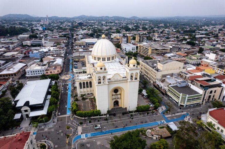 Aerial shot of the Metropolitan Cathedral in San Salvador's historic center, showcasing cityscape and urban architecture.