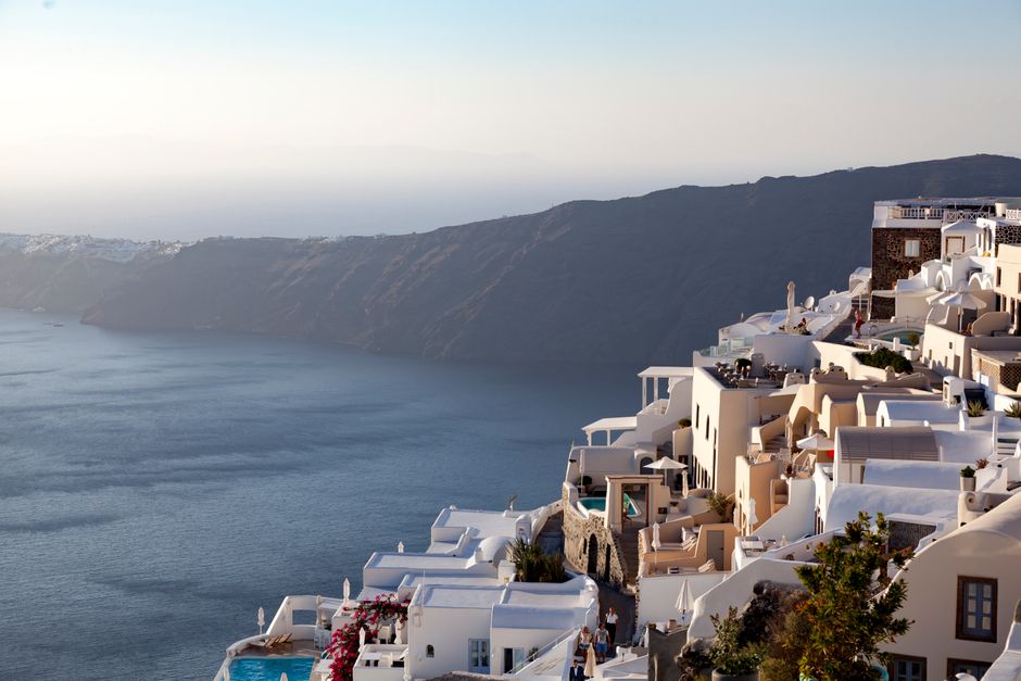 Stunning whitewashed architecture and sea view from Imerovigli, Santorini during sunset.