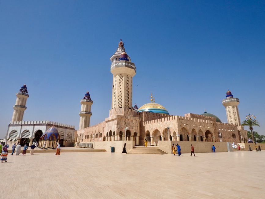 The Grand Mosque of Touba, Senegal, with its iconic minarets under a clear blue sky, showcasing Islamic architecture.
