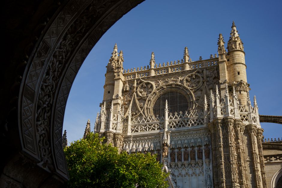 Explore the intricate gothic architecture of Seville Cathedral's facade with its stunning details.