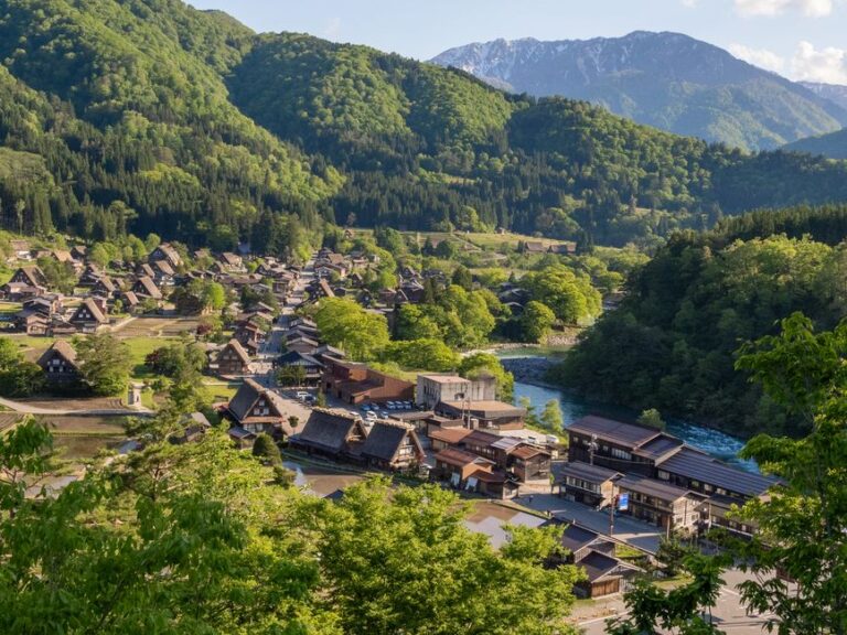 Explore the picturesque landscape of Shirakawa-go, a UNESCO World Heritage site in Japan, with traditional thatched-roof houses.