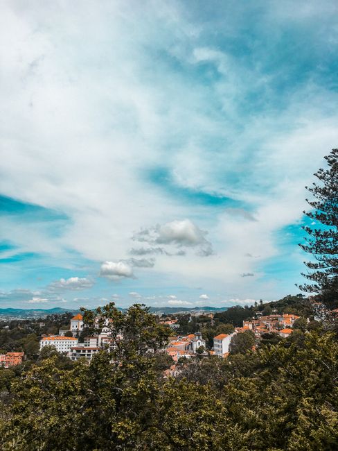 Beautiful landscape of Sintra, Portugal with vibrant sky and lush greenery.