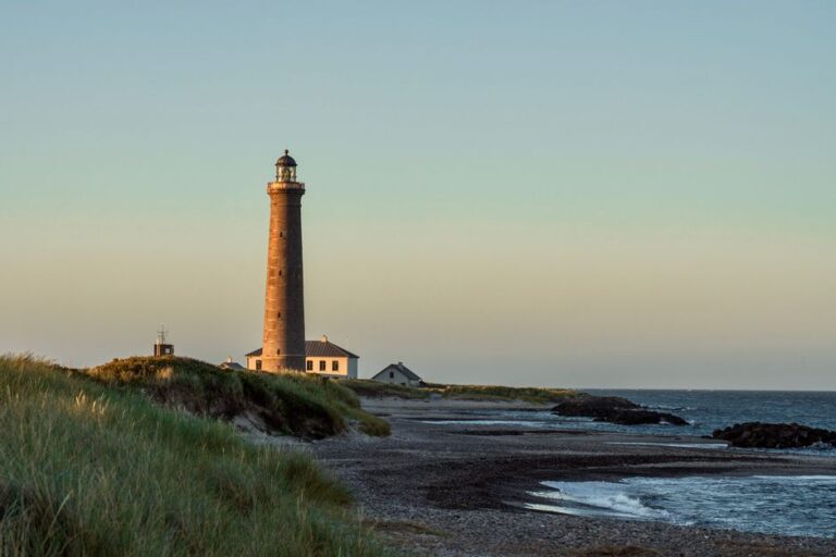 Beautiful view of Skagen Lighthouse at sunset with the North Sea in Denmark.