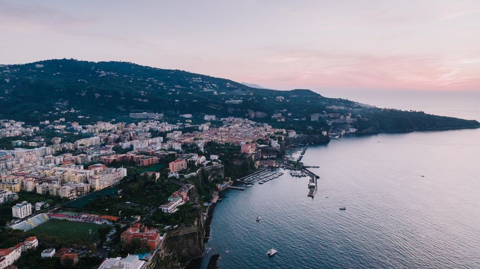 Scenic aerial view of Sorrento, Italy at sunset. A beautiful blend of cityscape and coastline.