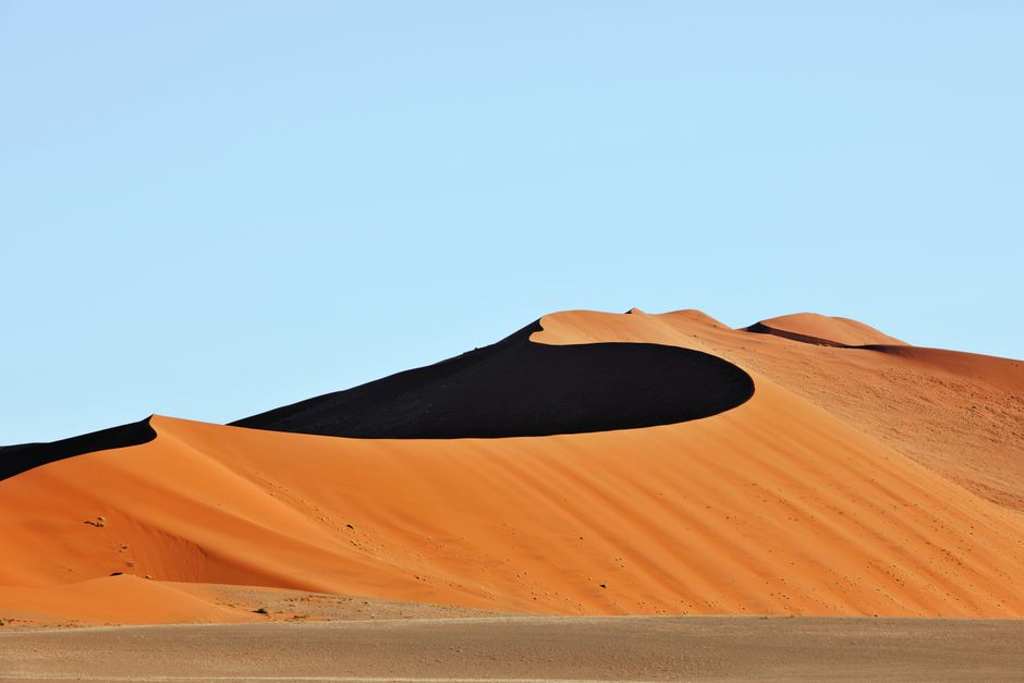 Stunning view of the vibrant orange sand dunes in Sossusvlei, showcasing natural beauty.