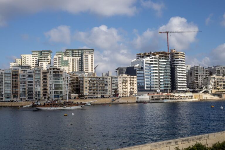 A beautiful cityscape featuring modern apartments and construction along the waterfront.