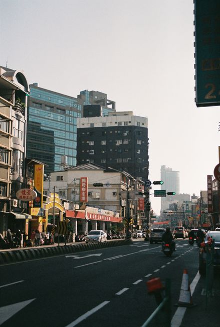Vibrant street view of Tainan, Taiwan, showcasing busy traffic and urban architecture.