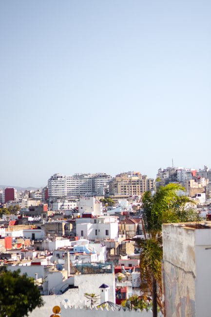 Explore the bustling skyline of Tangier with its diverse architecture under a clear sky.