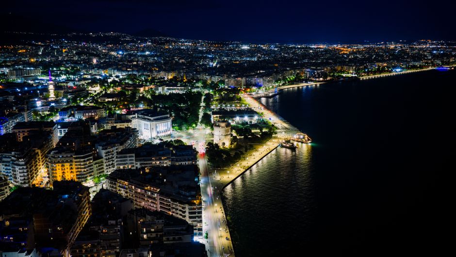 Stunning aerial night view of Thessaloniki's illuminated waterfront in Greece.