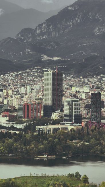 Scenic view of Tirana's cityscape nestled against majestic mountains.