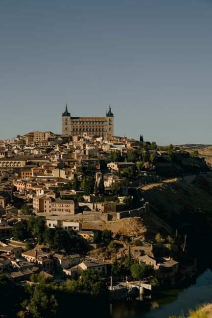 Breathtaking aerial view of Toledo, featuring the iconic Alcázar against a twilight sky.