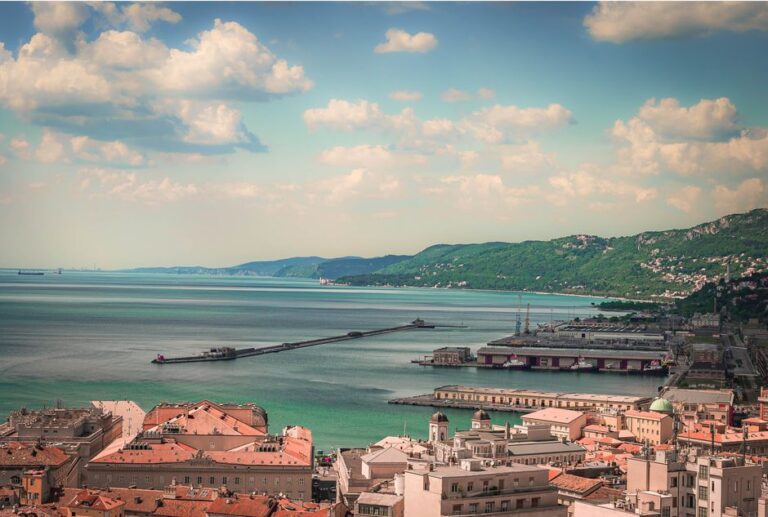 Scenic aerial view of a coastal city with charming architecture and a serene waterfront.