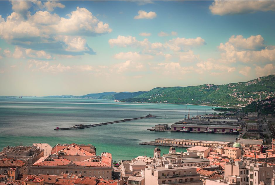 Scenic aerial view of a coastal city with charming architecture and a serene waterfront.