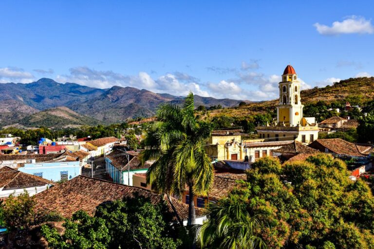 A beautiful view of Trinidad, Cuba, featuring mountains and colonial architecture.