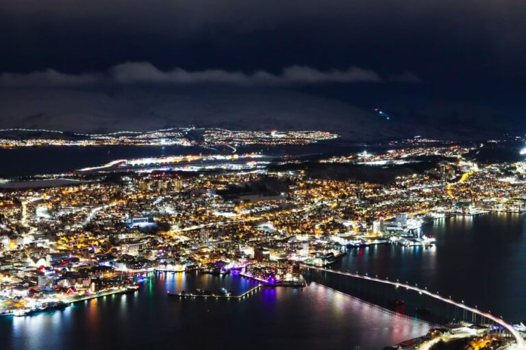 Captivating aerial photo showcasing Tromsø city lights and waterfront at night.