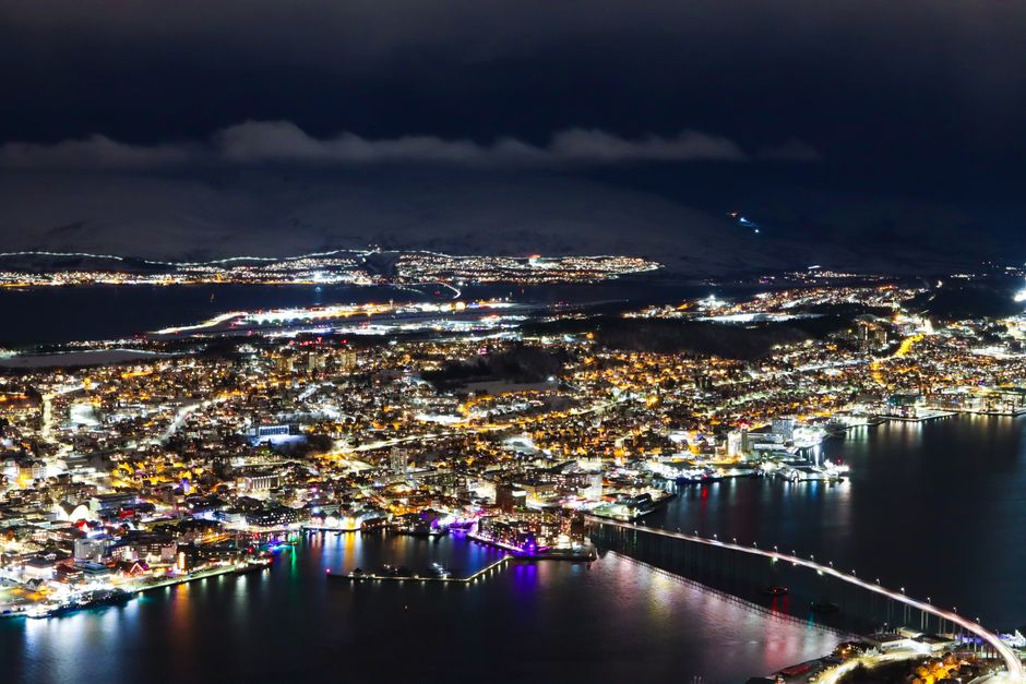Captivating aerial photo showcasing Tromsø city lights and waterfront at night.
