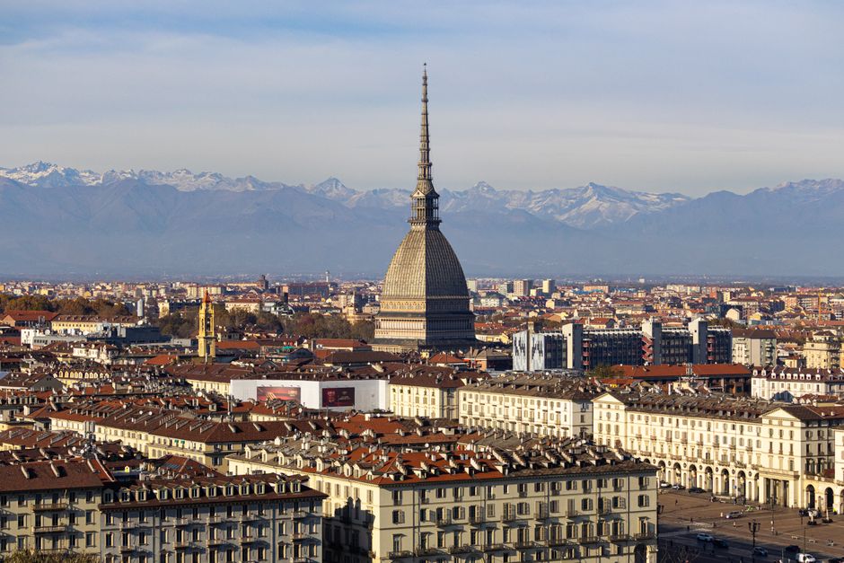 Discover the stunning cityscape of Turin with the iconic Mole Antonelliana and the Alps in the background.
