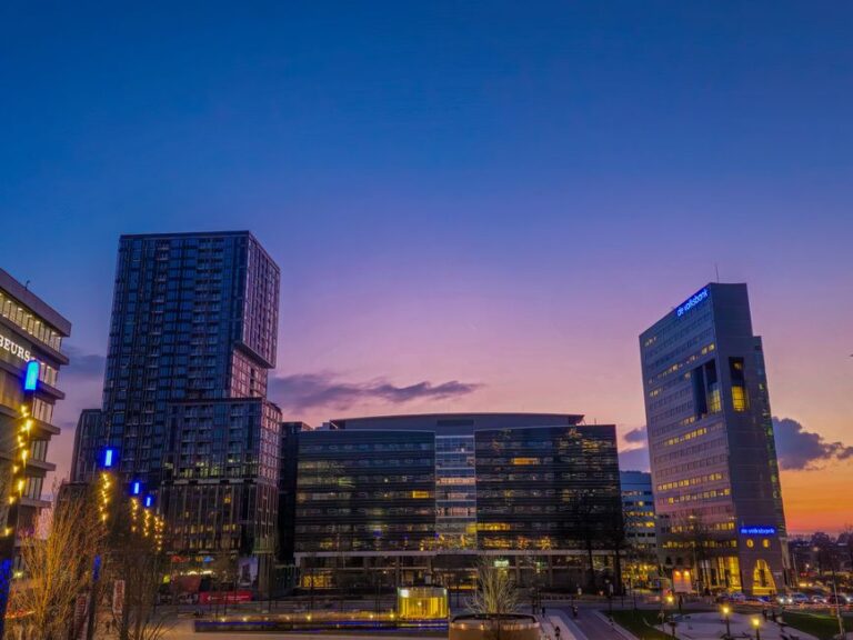 Stunning cityscape of Utrecht with illuminated high-rise buildings at twilight.