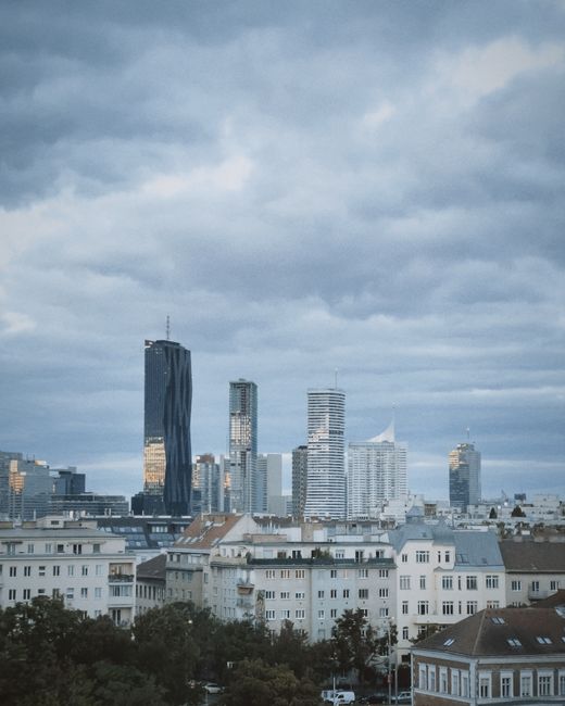 Skyline of Vienna showcasing modern skyscrapers under a cloudy sky.
