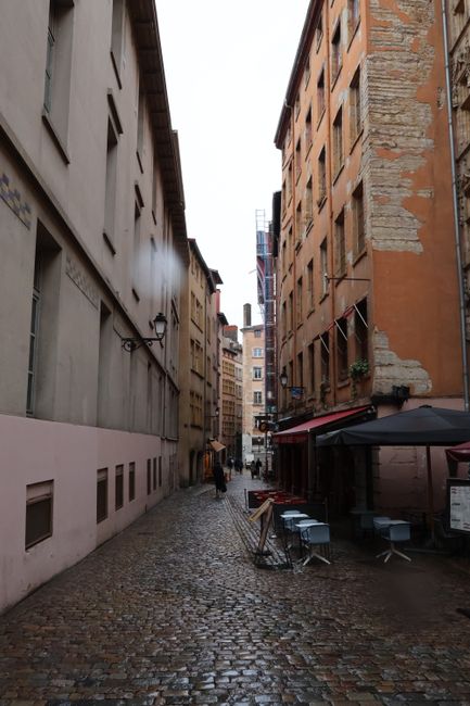 Explore a picturesque cobblestone street in Lyon, France, showcasing historic architecture.