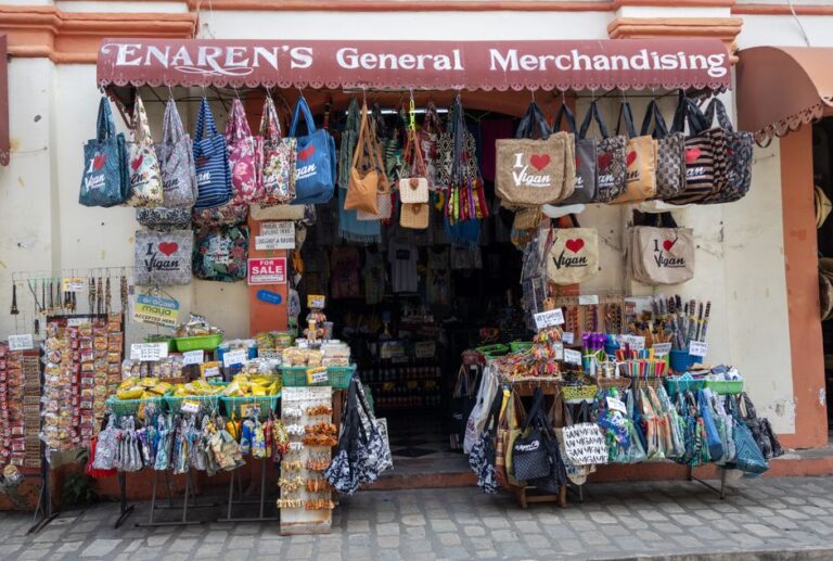Explore a colorful souvenir shop in Vigan, Philippines, showcasing bags, crafts, and snacks.