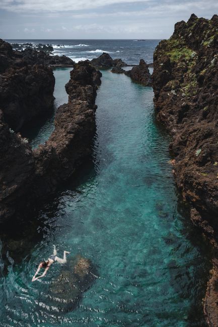 Explore the stunning natural swimming pools of Porto Moniz, Madeira, set against a backdrop of volcanic rock and clear waters.
