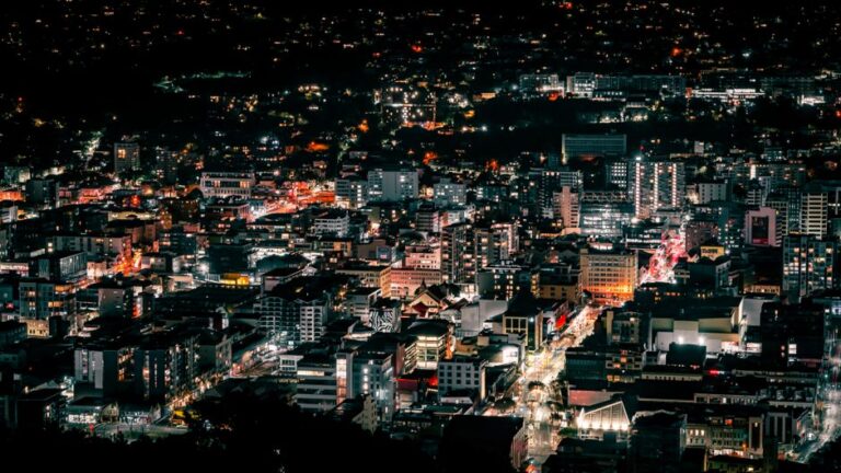 A stunning aerial view of Wellington's vibrant and illuminated cityscape during the night.