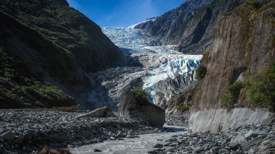 A scenic view of Franz Josef Glacier in New Zealand, showcasing its striking landscape and rugged beauty.