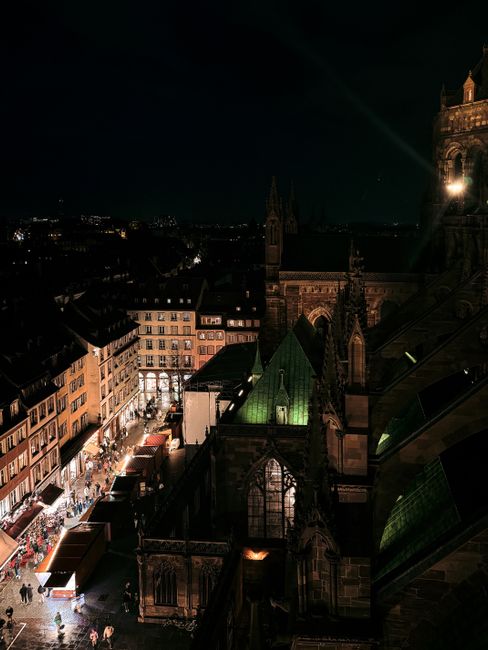 A captivating nighttime scene overlooking Strasbourg's historic architecture and vibrant city streets.